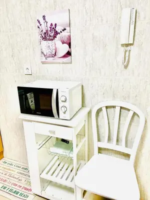 a microwave sitting on a counter next to a chair at Tineo centro in Tineo