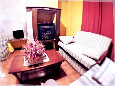 a living room with a couch and a wood stove at El Mirador Del Parque in Gúa
