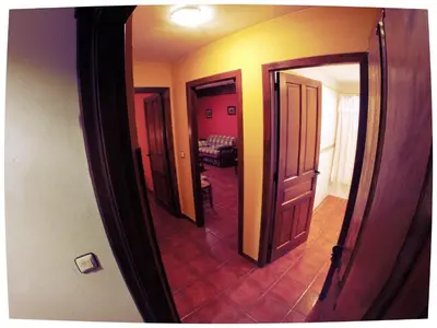 a hallway with three open doors and a room at El Mirador Del Parque in Gúa