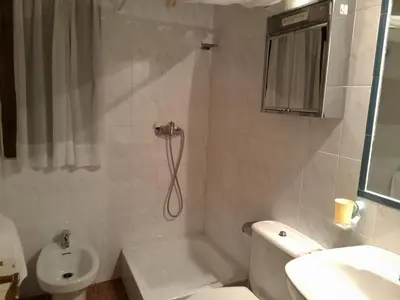 a bathroom with a toilet and a sink at El Mirador Del Parque in Gúa