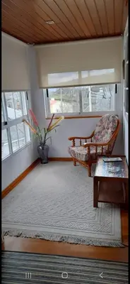 a living room with a couch and a table at Casa da Tita