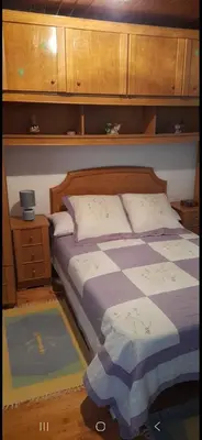 a bedroom with a bed and a nightstand and a bed sidx sidx at Casa da Tita