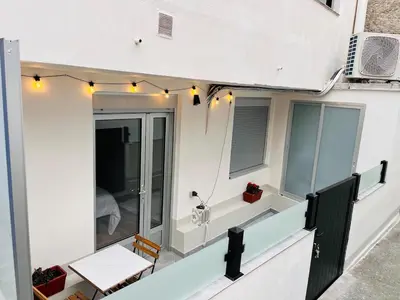 a balcony with lights on the side of a building at Valdeflores Flats Bj in Viveiro