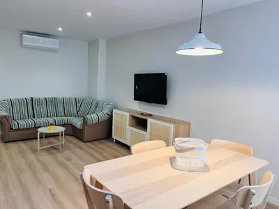a living room with a table and a couch at Valdeflores Flats Bj in Viveiro