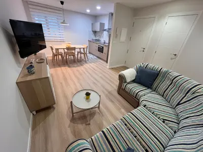a living room with a couch and a table at Valdeflores Flats Bj in Viveiro