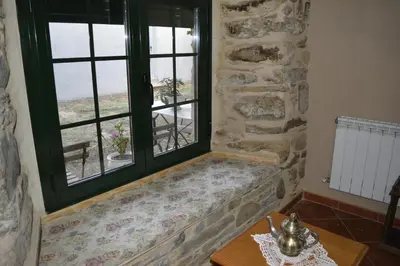 a window seat in a room with a table at La Casa de Rosa in Filiel