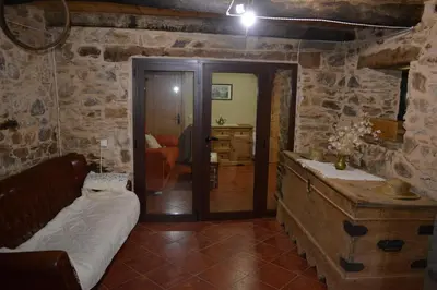 a room with a bed and a table in a room at La Casa de Rosa in Filiel