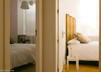a bedroom with a bed with a wooden headboard at A galería do san Ramón in Villalba