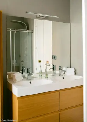 a bathroom with a sink and a large mirror at A galería do san Ramón in Villalba