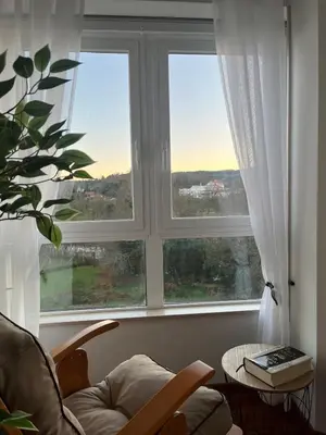 a living room with two large windows and a chair at Mirador del Tambre Etapa final del Camino in Sigüeiro