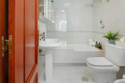 a white bathroom with a toilet and a sink at Mirador del Tambre Etapa final del Camino in Sigüeiro
