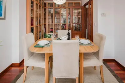 a dining room with a wooden table and chairs at Mirador del Tambre Etapa final del Camino in Sigüeiro
