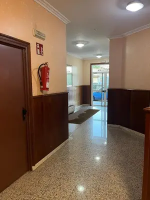 a lobby with a fire extinguisher on the wall at Mirador del Tambre Etapa final del Camino in Sigüeiro