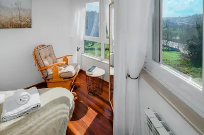 a room with a bed and a chair and a window at Mirador del Tambre Etapa final del Camino in Sigüeiro