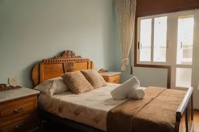 a bedroom with a bed with pillows and a window at The Dragon's Lair in Piñeiro