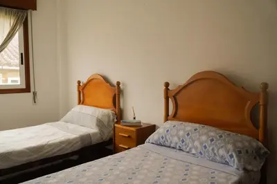 a bedroom with two beds and a nightstand next to a bed at The Dragon's Lair in Piñeiro