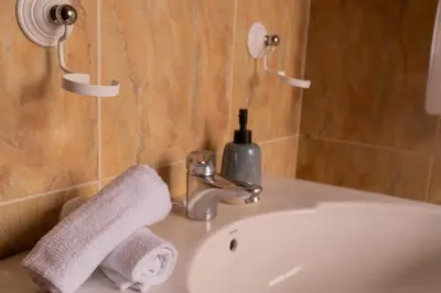 a bathroom sink with a soap dispenser on top of it at The Dragon's Lair in Piñeiro