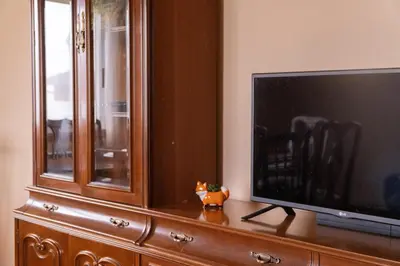 a flat screen tv sitting on top of a wooden cabinet at The Dragon's Lair in Piñeiro