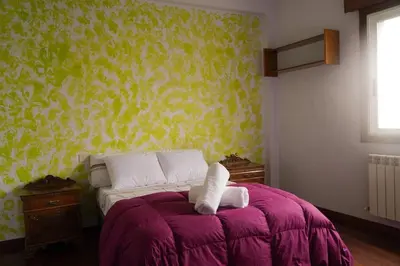a bedroom with a bed with a purple blanket at The Dragon's Lair in Piñeiro