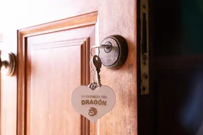 a lock on a door with a tag on it at The Dragon's Lair in Piñeiro