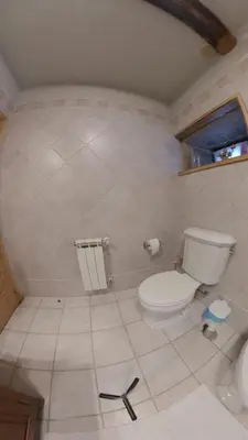 a bathroom with a white toilet and a window at Private Entire Home ,Old Town 6-min Walk to Cathedral in Santiago de Compostela