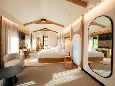 a bedroom with a bed and a table and a mirror at Hotel Sarela Natura in Santiago de Compostela