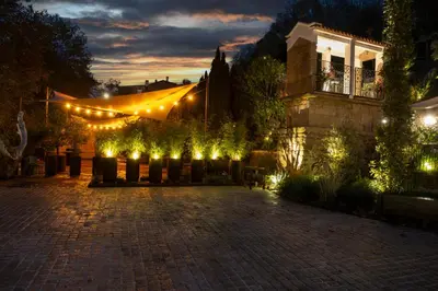 a courtyard with a tent and lights at night at Hotel Sarela Natura in Santiago de Compostela