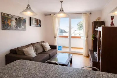 a living room with a couch and a table at Winahost Ático Viveiro in Viveiro