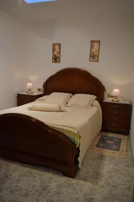 a bedroom with a large wooden bed with two night stands at Chuca House in Requiás