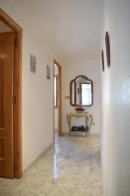 a hallway with a mirror and a table in a room at Chuca House in Requiás