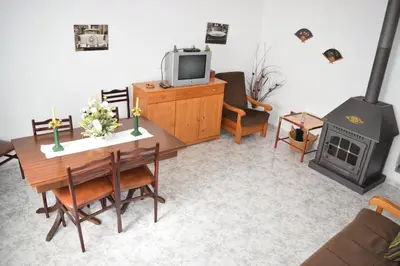 a living room with a dining table and a fireplace at Chuca House in Requiás