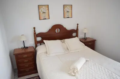 a bedroom with a large bed with two night stands at Chuca House in Requiás