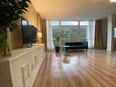a living room with a couch and a large window at Pensión Camino del Sil in Sobradelo
