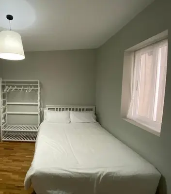a white bed in a room with a window at Pensión Camino del Sil in Sobradelo