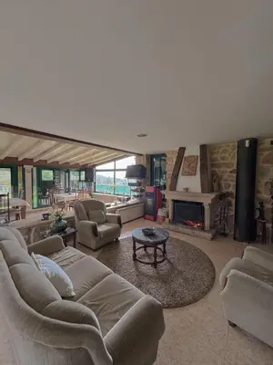 a large living room with couches and a fireplace at Aldea Figueiredo in San Amaro