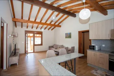 a kitchen and a living room with a table at YourHouse Casa Canastro in Allariz