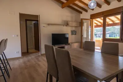 a dining room with a wooden table and chairs at YourHouse Casa Canastro in Allariz