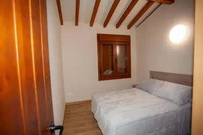 a small bedroom with a bed and a mirror at YourHouse Casa Canastro in Allariz