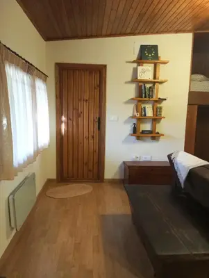 a room with a wooden door and a shelf at O Caliu das Airas in León