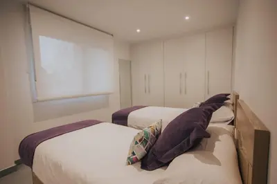 a bedroom with two beds and a window at Casas del Pedregal Apartamento 1 in A Estrada