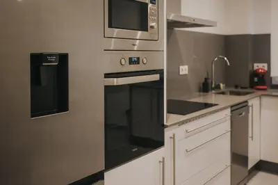 a kitchen with a stainless steel oven and a microwave at Casas del Pedregal Apartamento 1 in A Estrada