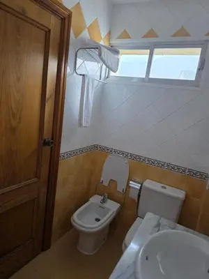 a bathroom with a toilet and a sink at Hotel Espada in A Rua