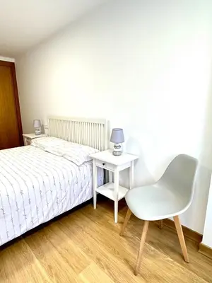 a bedroom with a bed and a table and a chair at Alice House in Miño