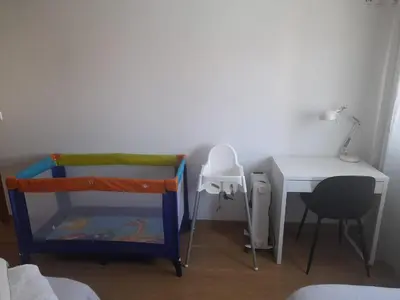 a bedroom with a desk and a bed and a table at Alice House in Miño