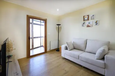 a living room with a couch and a window at YourHouse Casa Antonio in Amoeiro