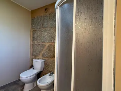 a bathroom with a toilet and a sink at YourHouse Casa Antonio in Amoeiro