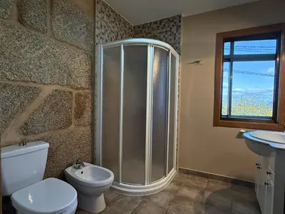 a bathroom with a shower and a toilet and a sink at YourHouse Casa Antonio in Amoeiro