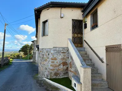 a building with a stone staircase leading to a door at YourHouse Casa Antonio in Amoeiro