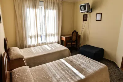 a hotel room with two beds and a chair at Casa Palomin