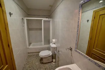 a bathroom with a toilet and a sink and a mirror at Casa Palomin